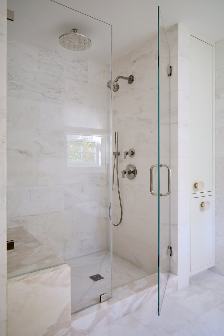 Marble walk-in shower with bench — representative work by Greaves Construction, near Garner, NC.